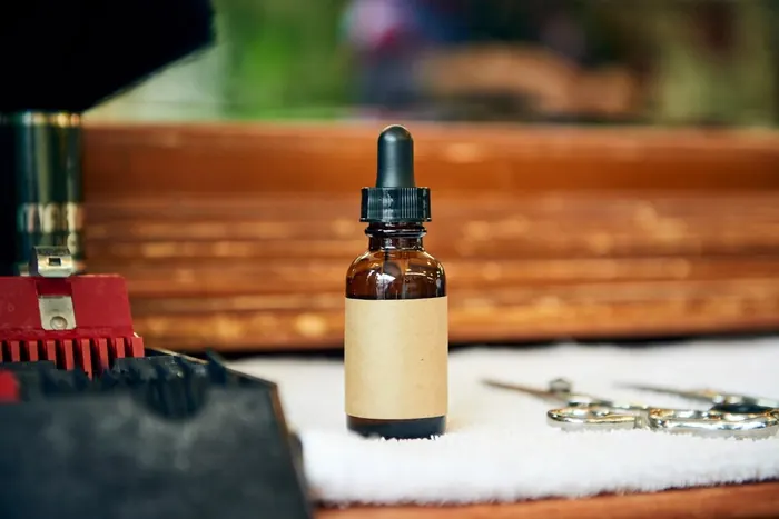 A bottle of beard oil on the barber's counter