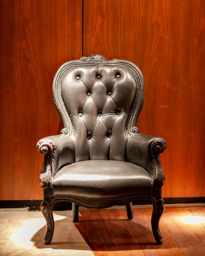 A tufted leather chair in warm light