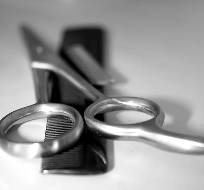 Barber scissors and a comb, black and white