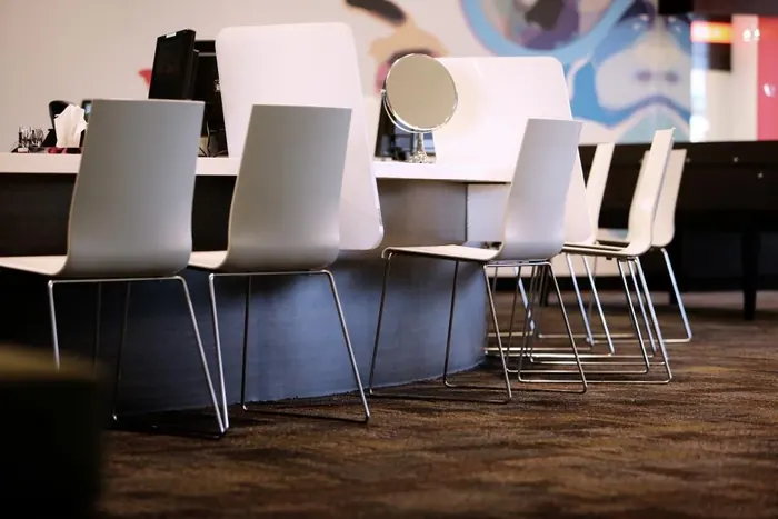 A row of white salon chairs